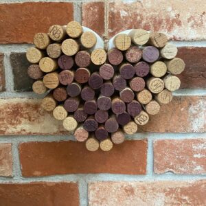 Medium wine corks on a heart shaped wood painted